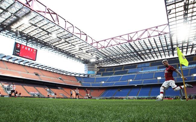 AC Milan's Samu Castillejo kicks from the corner in an empty stadium during the Serie A soccer match between AC Milan and Genoa at the San Siro stadium, in Milan, Italy, Sunday, March 8, 2020. Serie A played on Sunday despite calls from Italy’s sports minister and players’ association president to suspend the games in Italy’s top soccer division. (Spada/LaPresse via AP)