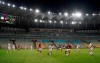 Players of Bangu, wearing white uniforms, and Flamengo play a Rio de Janeiro soccer league match at the Maracana stadium in Rio de Janeiro, Brazi, Thursday, June 18, 2020. Rio de Janeiro's soccer league resumed after a three-month hiatus because of the coronavirus pandemic. The match is being played without spectators to curb the spread of COVID-19. (AP Photo/Leo Correa)
