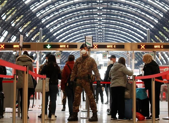 Police officers and soldiers check passengers leaving from Milan main train station, Italy, Monday, March 9, 2020. Italy took a page from China's playbook Sunday, attempting to lock down 16 million people — more than a quarter of its population — for nearly a month to halt the relentless march of the new coronavirus across Europe. Italian Premier Giuseppe Conte signed a quarantine decree early Sunday for the country's prosperous north. Areas under lockdown include Milan, Italy's financial hub and the main city in Lombardy, and Venice, the main city in the neighboring Veneto region. (AP Photo/Antonio Calanni)