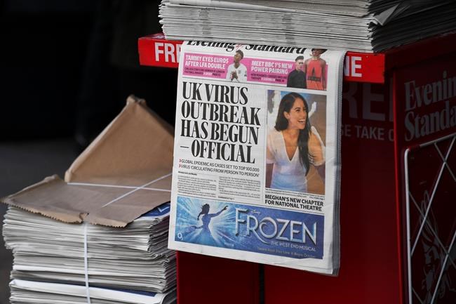 The front page of the Evening Standard reading 'UK virus outbreak has begun - official' is displayed at Bond Street Station, in London, Friday, March 6, 2020. British Prime Minister Boris Johnson said the U.K. will face a “substantial period of disruption” from the new coronavirus. (AP Photo/Alberto Pezzali)