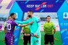 AC Milan's goalkeeper Gianluigi Donnarumma, center, and Fiorentina's German Pezzella, left, greet each other under a banner reading 