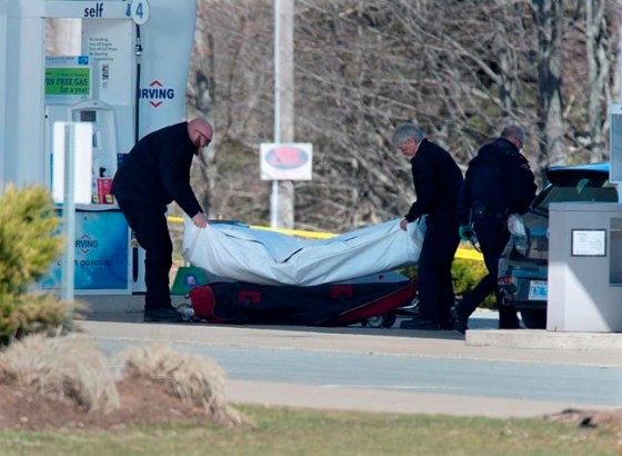 Workers with the medical examiner's office remove a body from a gas bar in Enfield, N.S. on Sunday, April 19, 2020. Before blazing a trail of carnage across Nova Scotia, the man behind one of Canada's worst mass killings attacked his longtime girlfriend — a story domestic violence experts say is eerily familiar. THE CANADIAN PRESS/Andrew Vaughan
