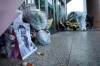 People pay condolence in front of flowers lying near a photo of the late Dr. Li Wenliang at a hospital in Wuhan in central China's Hubei province, Friday, Feb. 7, 2020. The death of the doctor who was reprimanded for warning about China's new virus triggered an outpouring Friday of praise for him and fury that communist authorities put politics above public safety. In death, Dr. Li Wenliang became the face of simmering anger at the ruling Communist Party's controls over information and complaints that officials lie about or hide disease outbreaks, chemical spills, dangerous consumer products or financial frauds. (Chinatopix via AP)