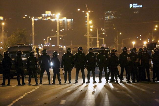Police block the road to protect against demonstrators after the Belarusian presidential election in Minsk, Belarus, late Sunday, Aug. 9, 2020. Police and protesters clashed in Belarus' capital and the major city of Brest on Sunday after the presidential election in which the country’s longtime authoritarian leader Alexander Lukashenko, who has ruled for a quarter-century, sought a sixth term in office. (AP Photo)