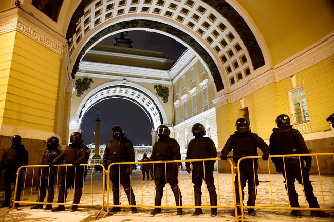 Police block the Palace Square to stop Navalny supporters during a protest in St. Petersburg, Russia, Tuesday, Feb. 2, 2021. A Moscow court has ordered Russian opposition leader Alexei Navalny to prison for more than 2 1/2 years on charges that he violated the terms of his probation while he was recuperating in Germany from nerve-agent poisoning. Navalny, who is the most prominent critic of President Vladimir Putin, had earlier denounced the proceedings as a vain attempt by the Kremlin to scare millions of Russians into submission. (AP Photo/Dmitri Lovetsky)