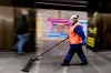 An employee wearing face masks and gloves to protect against the COVID-19 coronavirus cleans a floor at a subway station in Kyiv, Ukraine on Monday, June 1, 2020. Ukraine continued to ease its coronavirus restrictions Monday, lifting a ban on intercity travel and allowing gyms and swimming pools to reopen. (AP Photo/Evgeniy Maloletka)