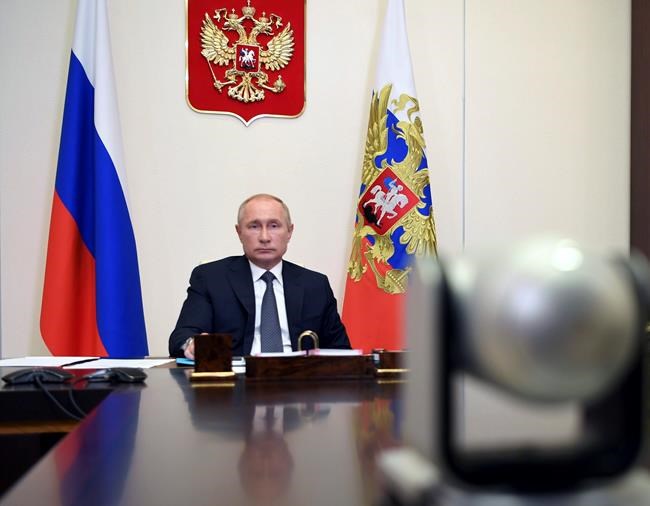 Russian President Vladimir Putin attends a cabinet meeting at the Novo-Ogaryovo residence outside Moscow, Russia, Tuesday, Aug. 11, 2020. Putin says that a coronavirus vaccine developed in the country has been registered for use and one of his daughters has already been inoculated. Speaking at a government meeting Tuesday, Aug. 11, 2020, Putin said that the vaccine has proven efficient during tests, offering a lasting immunity from the coronavirus. (Alexei Nikolsky, Sputnik, Kremlin Pool Photo via AP)