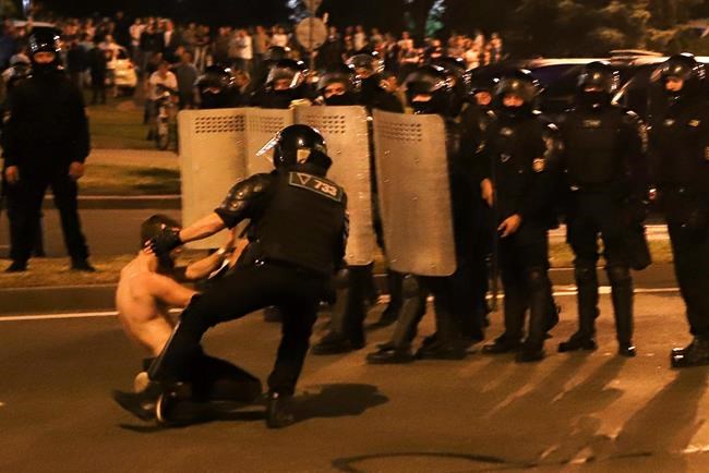 A police officer detains a protester during a rally after the presidential election in Minsk, Belarus, Sunday, Aug. 9, 2020. Police and protesters clashed in Belarus' capital and the major city of Brest on Sunday after the presidential election in which the authoritarian leader who has ruled for a quarter-century sought a sixth term in office. (AP Photo)
