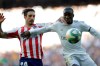 Atletico Madrid's Sime Vrsaljko, left, challenges for the ball with Real Madrid's Ferland Mendy during a Spanish La Liga soccer match between Real Madrid and Atletico Madrid at the Santiago Bernabeu stadium in Madrid, Saturday, Feb. 1, 2020. (AP Photo/Bernat Armangue)