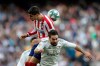 Atletico Madrid's Alvaro Morata heads the ball flanked by Real Madrid's Dani Carvajal during a Spanish La Liga soccer match between Real Madrid and Atletico Madrid at the Santiago Bernabeu stadium in Madrid, Saturday, Feb. 1, 2020. (AP Photo/Bernat Armangue)