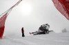 A snowcat works on the course after a women's alpine combined race was canceled due to heavy snowfall, at the alpine ski World Championships in Cortina d'Ampezzo, Italy, Monday, Feb. 8, 2021. (AP Photo/Gabriele Facciotti)