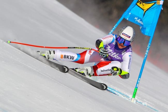 Switzerland's Corinne Suter speeds down the course during an alpine ski, women's World Cup super-G in St. Anton, Austria, Sunday, Jan.10, 2021. (AP Photo/Marco Trovati)