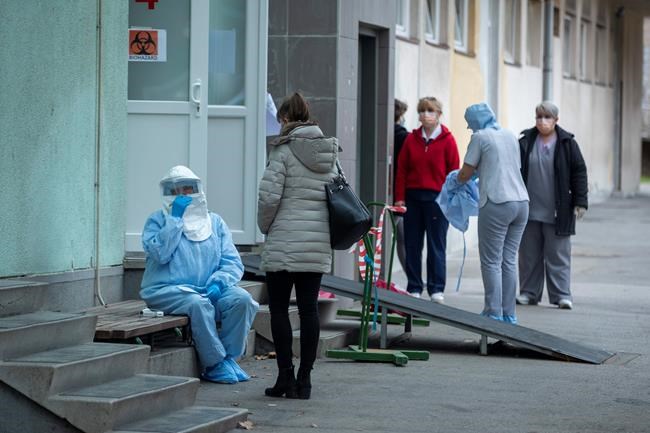 A health worker takes notes at the infectious disease clinic in Zagreb, Croatia, where the first coronavirus case in Croatia is hospitalized, Tuesday, Feb. 25, 2020. Croatia confirmed its first case of coronavirus in a man who had been to Milan, the capital of Lombardy, Italy. (AP Photo/Darko Bandic)