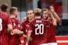 AC Milan's Hakan Calhanoglu, right, celebrates after scoring his side's opening goal during the Serie A soccer match between AC Milan and Atalanta at the San Siro stadium, in Milan, Italy, Friday, July 24, 2020. (AP Photo/Antonio Calanni)