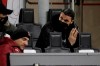 AC Milan's Zlatan Ibrahimovic, right, sits on the stands ahead of a Serie A soccer match between AC Milan and Napoli, at the San Siro stadium in Milan, Italy, Sunday, March 14, 2021. (AP Photo/Luca Bruno)