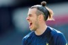 Tottenham's Gareth Bale smiles during a warmup ahead of the English Premier League soccer match between Tottenham Hotspur and Manchester United at the Tottenham Hotspur Stadium in London, Sunday, April 11, 2021. (Adrian Dennis/Pool via AP)