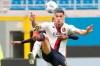 Genoa's Gianluca Scamacca is challenged by AC Milan's Pierre Kalulu, rear, during the Serie A soccer match between AC Milan and Genoa at the San Siro stadium in Milan, Italy, Sunday, April 18, 2021. (AP Photo/Antonio Calanni)