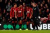Bournemouth's Nathan Ake, center, is helped to walk from the field as being substituted by Bournemouth's Jack Simpson during the English Premier League soccer match between Bournemouth and Liverpool at the Vitality stadium in Bournemouth, England, Saturday, Dec. 7, 2019. (AP Photo/Alastair Grant)