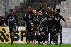 Lyon players celebrate after Lyon's Karl Toko Ekambi scored his side's opening goal during the French League One soccer match between Marseille and Lyon at the Stade Veledrome stadium in Marseille, France, Sunday, Feb. 28, 2021. (AP Photo/Daniel Cole)