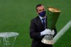 An UEFA official carries the trophy ahead of the Europa League final soccer match between Sevilla and Inter Milan in Cologne, Germany, Friday, Aug. 21, 2020. (Friedemann Vogel/Pool via AP)
