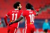 Liverpool's Mohamed Salah, left, celebrates after scoring his side's opening goal during the Champions League round of 16 second leg soccer match between Liverpool and RB Leipzig at the Puskas Arena stadium in Budapest, Hungary, Wednesday, March 10, 2021. (AP Photo/Laszlo Balogh)
