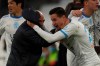 Marseille's Florian Thauvin, right, celebrates with Marseille's coach Jorge Sampaoli after scoring his side's second goal during the French League One soccer match between Marseille and Brest at the Stade Veledrome stadium in Marseille, France, Saturday, March 13, 2021. (AP Photo/Daniel Cole)