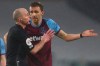 West Ham's Tomas Soucek, center, talks to the referee after he was shown a red card during the English Premier League match between Fulham and West Ham at the Craven Cottage stadium in London, Saturday, Feb. 6, 2021. (Clive Rose/Pool via AP)