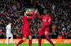 Liverpool's Mohamed Salah, front left, celebrates with Liverpool's Sadio Mane after scoring his side's opening goal during the English Premier League soccer match between Liverpool and Sheffield United at Anfield Stadium, Liverpool, England, Thursday, Jan. 2, 2020. (AP Photo/Jon Super)