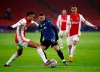 Ajax's Noussair Mazraoui, left, duels for the ball with Atalanta's Papu Gomez, centre, during the group D Champions League soccer match between Ajax and Atalanta at the Johan Cruyff ArenA in Amsterdam, Netherlands, Wednesday, Dec. 9, 2020. (AP Photo/Peter Dejong)