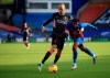 Liverpool's Fabinho, left, duels for the ball with Crystal Palace's Wilfried Zaha during the English Premier League soccer match between Crystal Palace and Liverpool at Selhurst Park stadium in London, Saturday, Dec. 19, 2020. (Adam Davy/Pool via AP)