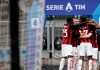 AC Milan's Hakan Calhanoglu celebrates with teammates after scoring his side's opening goal during the Serie A soccer match between AC Milan and Sassuolo at the San Siro stadium, in Milan, Italy, Wednesday, April 21, 2021. (AP Photo/Antonio Calanni)