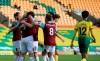 Burnley's Chris Wood celebrates with teammates after scoring his side's opening goal during the English Premier League soccer match between Norwich City and Burnley at Carrow Road Stadium in Norwich, England, Saturday, July 18, 2020. (Lindsey Parnaby/Pool via AP)