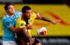 Watford's Troy Deeney, right, duels for the ball with Manchester City's Eric Garcia during the English Premier League soccer match between Watford and Manchester City at the Vicarage Road Stadium in Watford, England, Tuesday, July 21, 2020. (Adrian Dennis/Pool via AP)