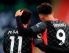 Liverpool's Roberto Firmino, right, celebrates with Liverpool's Mohamed Salah after scoring his side's fifth goal during the English Premier League soccer match between Crystal Palace and Liverpool at Selhurst Park stadium in London, Saturday, Dec. 19, 2020. (Adam Davy/Pool via AP)
