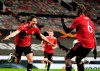 Manchester United's Edinson Cavani, left, celebrates after scoring his side's third goal during the Europa League semi final, first leg soccer match between Manchester United and Roma at Old Trafford in Manchester, England, Thursday, April 29, 2021. (AP Photo/Jon Super)