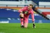 Everton's goalkeeper Jordan Pickford reacts after sustaining an injury during the English Premier League soccer match between Everton and Burnley at Goodison Park in Liverpool, England, Saturday, March 13, 2021. (Peter Powell/Pool via AP)