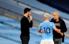 Manchester City's Sergio Aguero, centre, speaks with Manchester City's head coach Pep Guardiola after being substituted during the English Premier League soccer match between Manchester City and Arsenal at the Etihad stadium in Manchester, England, Saturday, Oct. 17, 2020. (Michael Regan/Pool via AP)