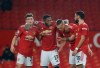 Manchester United's Scott McTominay, second right, celebrates with teammates after scoring his side's sixth goal during the English Premier League soccer match between Manchester United and Southampton, at the Old Trafford stadium in Manchester, England, Tuesday, Feb. 2, 2021.(Phil Noble/Pool via AP)
