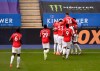 Manchester United's Bruno Fernandes celebrates with teammates after scoring his side's opening goal from the penalty spot during the English Premier League soccer match between Leicester City and Manchester United at the King Power Stadium, in Leicester, England, Sunday, July 26, 2020. (Oli Scarff/Pool via AP)