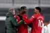 Manchester United's Paul Pogba, centre, celebrates with Manchester United's manager Ole Gunnar Solskjaer, left, and Manchester United's Marcus Rashford at the end of the English Premier League soccer match between Fulham and Manchester United at the Craven Cottage stadium in London, Wednesday, Jan. 20, 2021. (Peter Cziborra/Pool via AP)