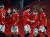 Manchester United players celebrate after Anthony Martial, right, scoring his side's eighth goal during the English Premier League soccer match between Manchester United and Southampton, at the Old Trafford stadium in Manchester, England, Tuesday, Feb. 2, 2021. (Phil Noble/Pool via AP)