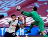 West Ham's goalkeeper Lukasz Fabianski, right, makes a save in front of Tottenham's Dele Alli, left, during the English Premier League soccer match between West Ham United and Tottenham at the London Stadium in London, Saturday, Feb. 21, 2021. (Neil Hall/Pool via AP)