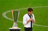 Inter Milan's head coach Antonio Conte walks past the trophy after the Europa League final soccer match between Sevilla and Inter Milan in Cologne, Germany, Friday, Aug. 21, 2020. (Ina Fassbender/Pool via AP)
