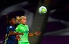 Lyon's Kadeisha Buchanan, left, duels for the ball with Wolfsburg's Pernille Harder during the Women's Champions League final soccer match between Wolfsburg and Lyon at the Anoeta stadium in San Sebastian, Spain, Sunday, Aug. 30, 2020. (Gabriel Buoys/Pool via AP)