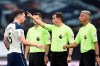 Tottenham's Pierre-Emile Hojbjerg, left, talks to referee Peter Bankes during the English Premier League soccer match between Tottenham and Newcastle at the Tottenham Hotspur Stadium in London, Sunday, Sept. 27, 2020. (Daniel Leal-Olivas/Pool via AP)