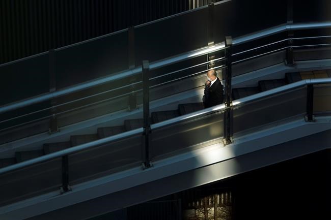 A man with a protective mask walks on a pedestrian bridge Thursday, Feb. 27, 2020, in Tokyo. At a government task force meeting Wednesday on the virus outbreak, Prime Minister Shinzo Abe said he was asking organizers to cancel or postpone major sports or cultural events over the next two weeks. (AP Photo/Eugene Hoshiko)