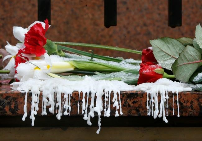 Wax from melted candles and flowers, at the Canadian Embassy in memory of victims of the Ukrainian 737-800 plane that crashed on the outskirts of Tehran, during a national day of mourning in Kyiv, Ukraine, Thursday, Jan. 9, 2020. A Ukrainian passenger jet carrying 176 people has crashed just minutes after taking off from the Iranian capital's main airport, Wednesday, turning farmland on the outskirts of Tehran into fields of debris and killing all on board. (AP Photo/Efrem Lukatsky)