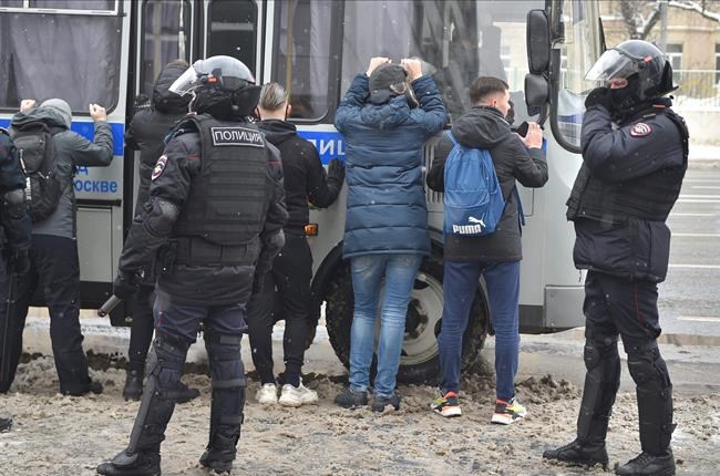 Police detain protesters during a protest against the jailing of opposition leader Alexei Navalny in Moscow, Russia, Sunday, Jan. 31, 2021. Thousands of people have taken to the streets across Russia to demand the release of jailed opposition leader Alexei Navalny, keeping up the wave of nationwide protests that have rattled the Kremlin. Hundreds have been detained by police. (AP Photo/Dmitry Serebryakov)