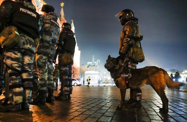 Servicemen of the Russian National Guard (Rosgvardia) gather at the Red Square to prevent a protest rally in Moscow, Russia, Tuesday, Feb. 2, 2021. A Moscow court has ordered Russian opposition leader Alexei Navalny to prison for more than 2 1/2 years on charges that he violated the terms of his probation while he was recuperating in Germany from nerve-agent poisoning. Navalny, who is the most prominent critic of President Vladimir Putin, had earlier denounced the proceedings as a vain attempt by the Kremlin to scare millions of Russians into submission. (AP Photo/Pavel Golovkin)