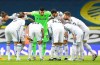 Leeds United players huddle before the English Premier League soccer match between Leeds United and Brighton and Hove Albion at Elland Road Stadium in Leeds, England, Saturday, Jan.16, 2021. (Peter Powell/Pool via AP)